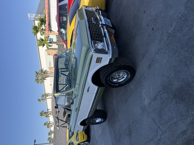 A restored and lifted 1972 Chevrolet K5 Blazer in the shop lot.
